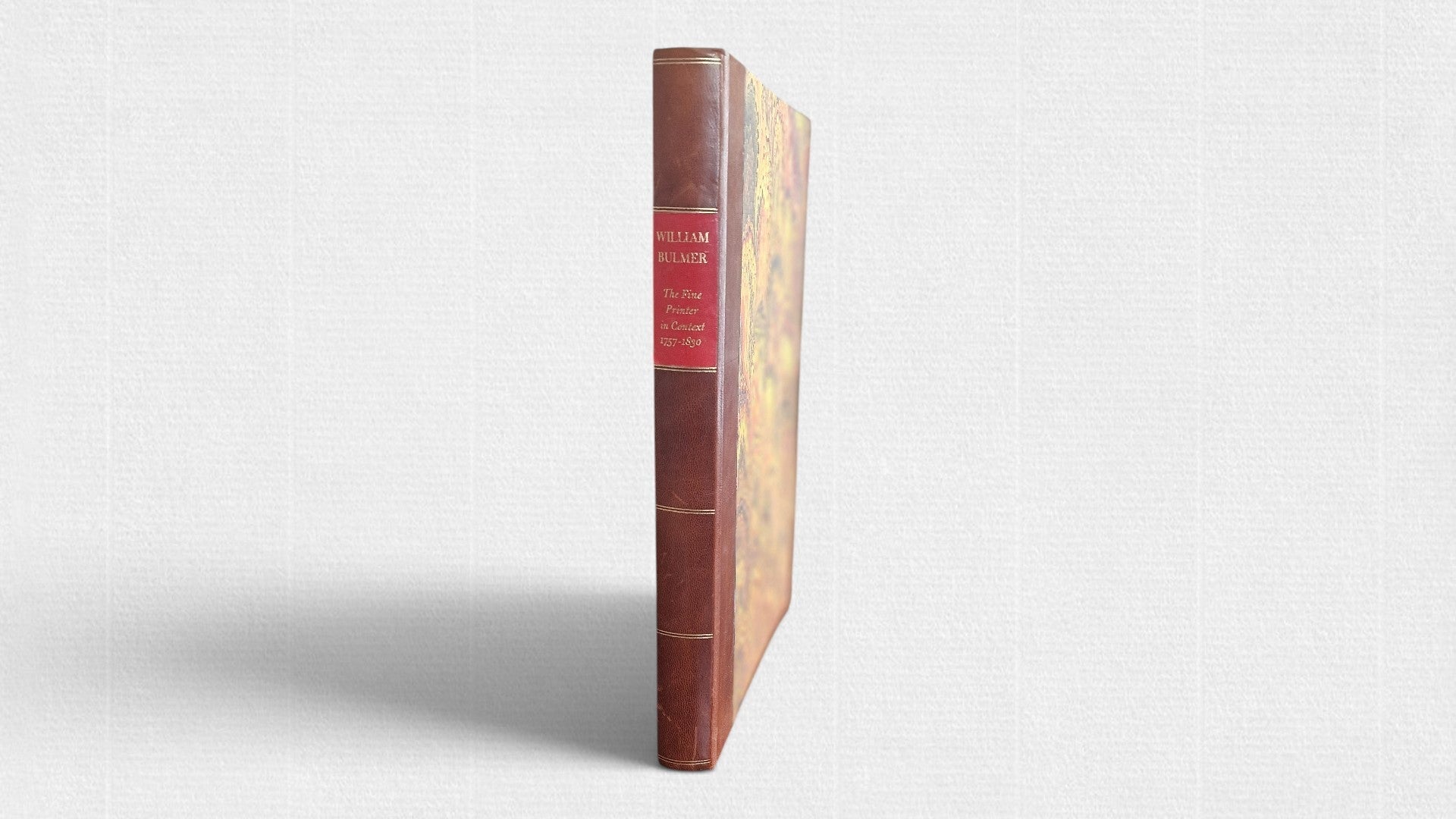 Spine view of William Bulmer: The Fine Printer in Context 1757–1830, showing a half-leather binding with gilt lettering and marbled boards.