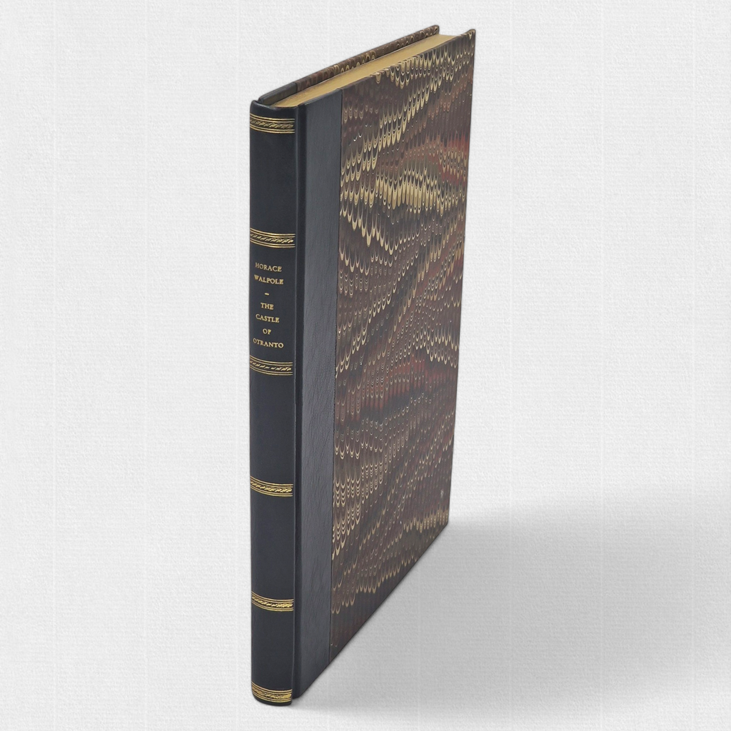 Front board of The Castle of Otranto showing hand-marbled paper sides and leather spine with gilt decoration.