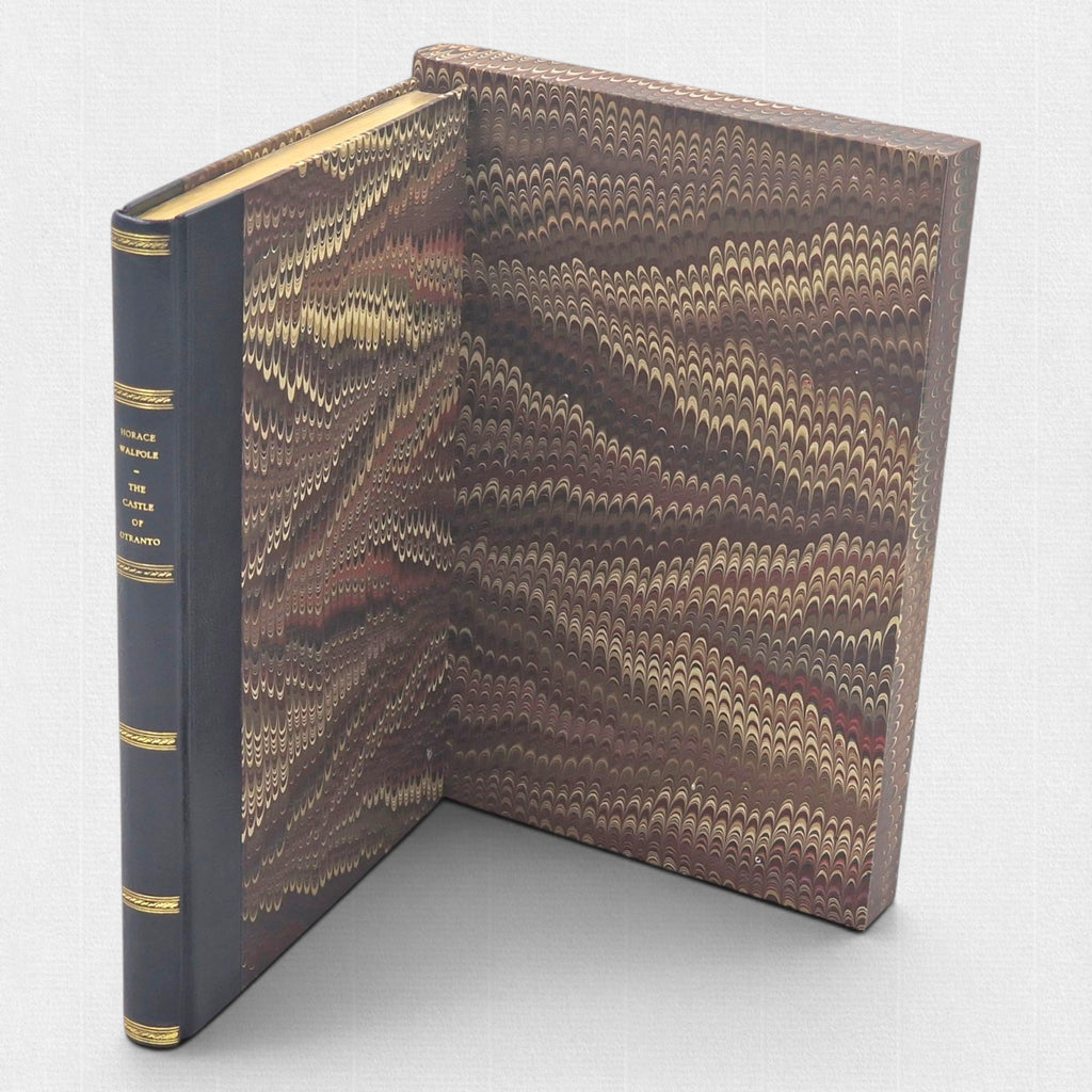 The Castle of Otranto fine press edition beside its open marbled slipcase, showing leather spine and decorative paper sides.