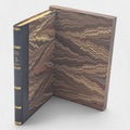 The Castle of Otranto fine press edition beside its open marbled slipcase, showing leather spine and decorative paper sides.