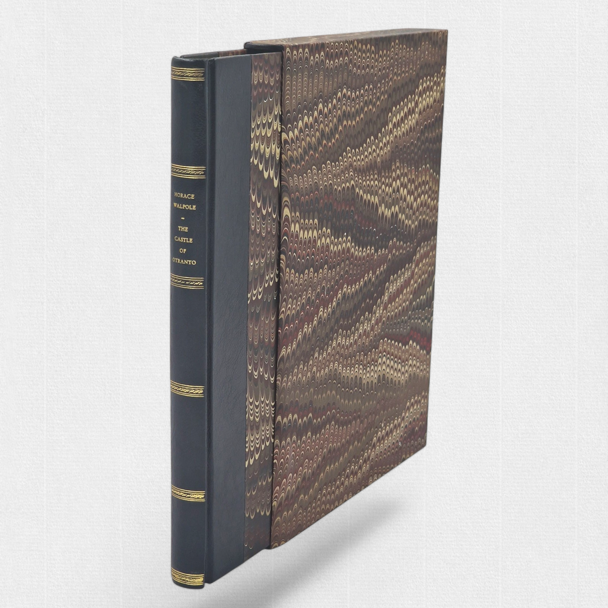 Angled view of The Castle of Otranto with marbled slipcase and half-leather binding by Woodbank Press.