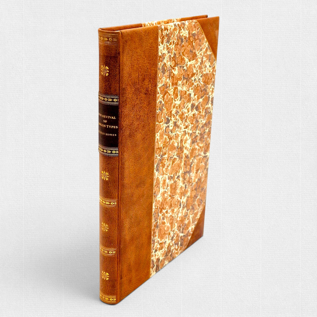 Fine binding of The Revival of Caslon Types by Justin Howes, hand-bound in leather with marbled paper boards and gilt spine lettering.