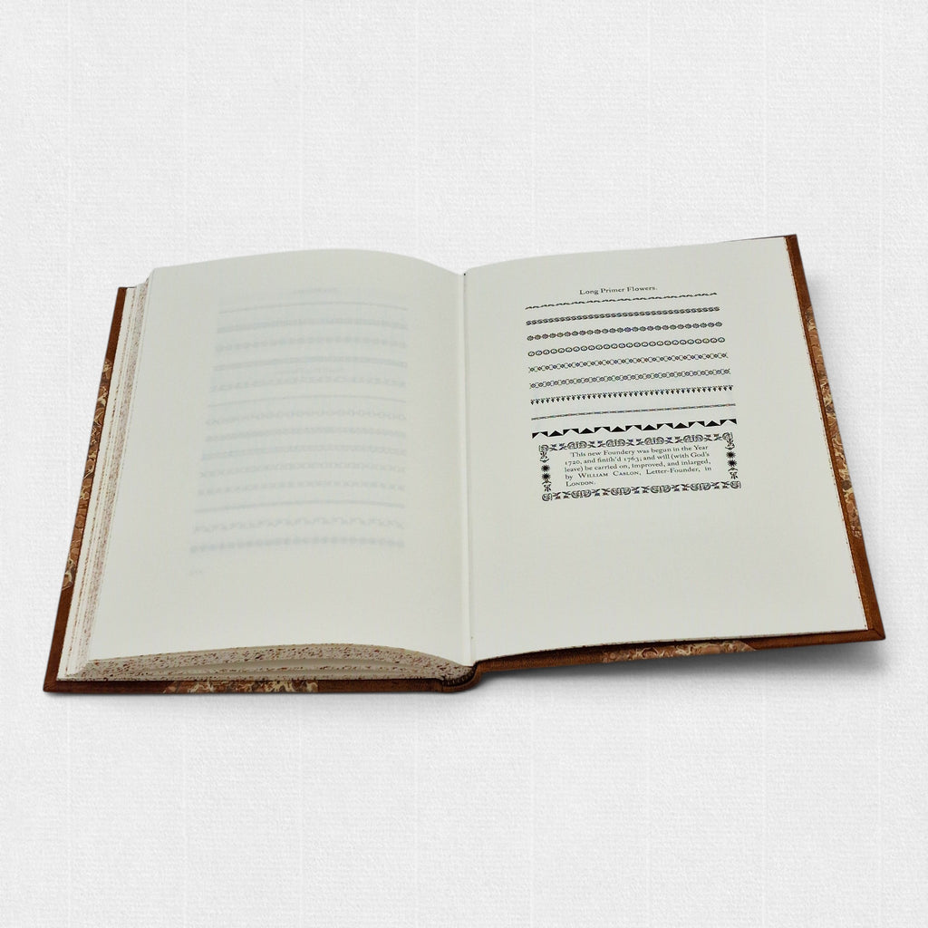 Interior spread of The Revival of Caslon Types showing Long Primer floral ornaments and decorative borders from the Caslon foundry.