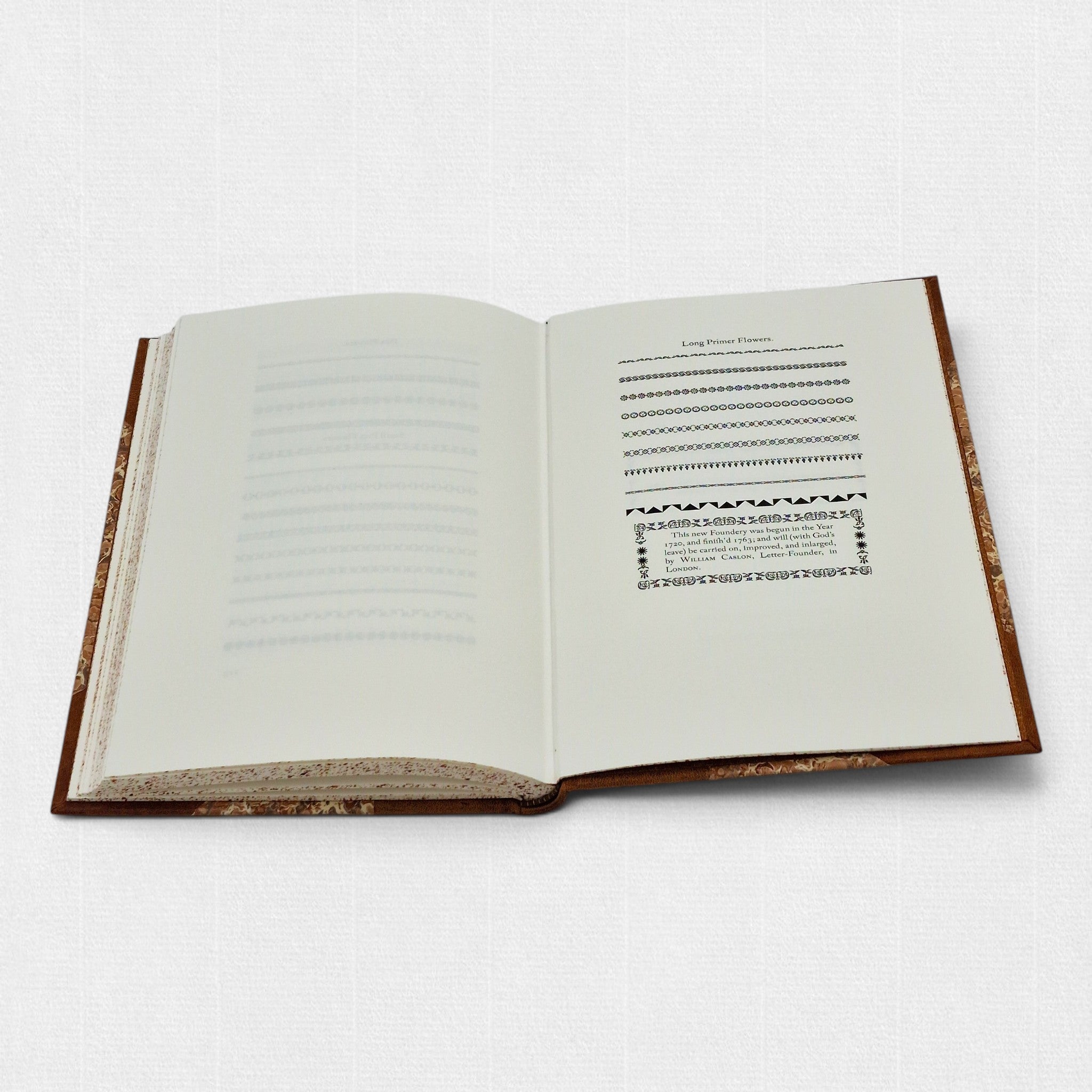 Interior spread of The Revival of Caslon Types showing Long Primer floral ornaments and decorative borders from the Caslon foundry.
