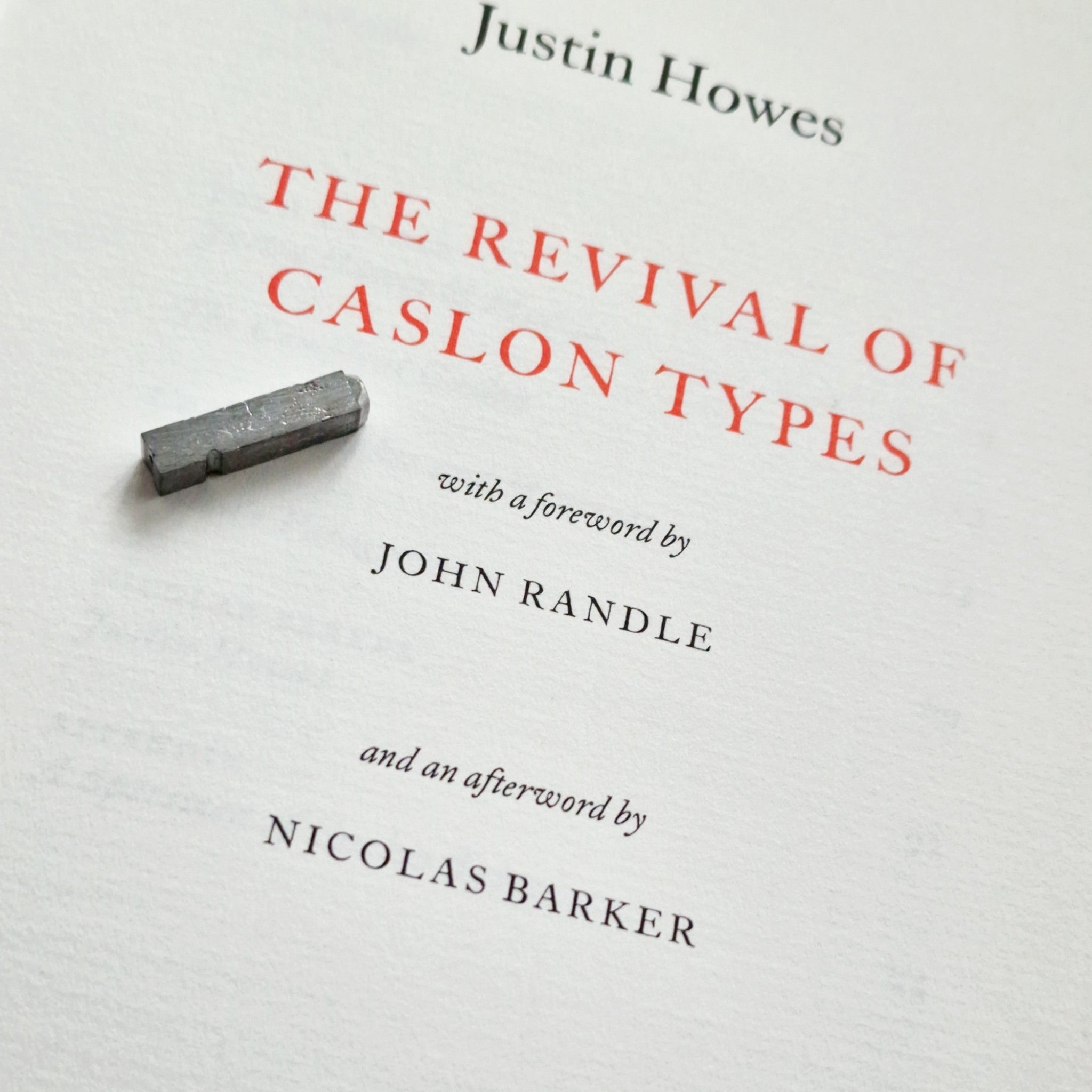 Title page detail of The Revival of Caslon Types by Justin Howes, featuring the printed title, foreword by John Randle, afterword by Nicolas Barker, and a metal type element.