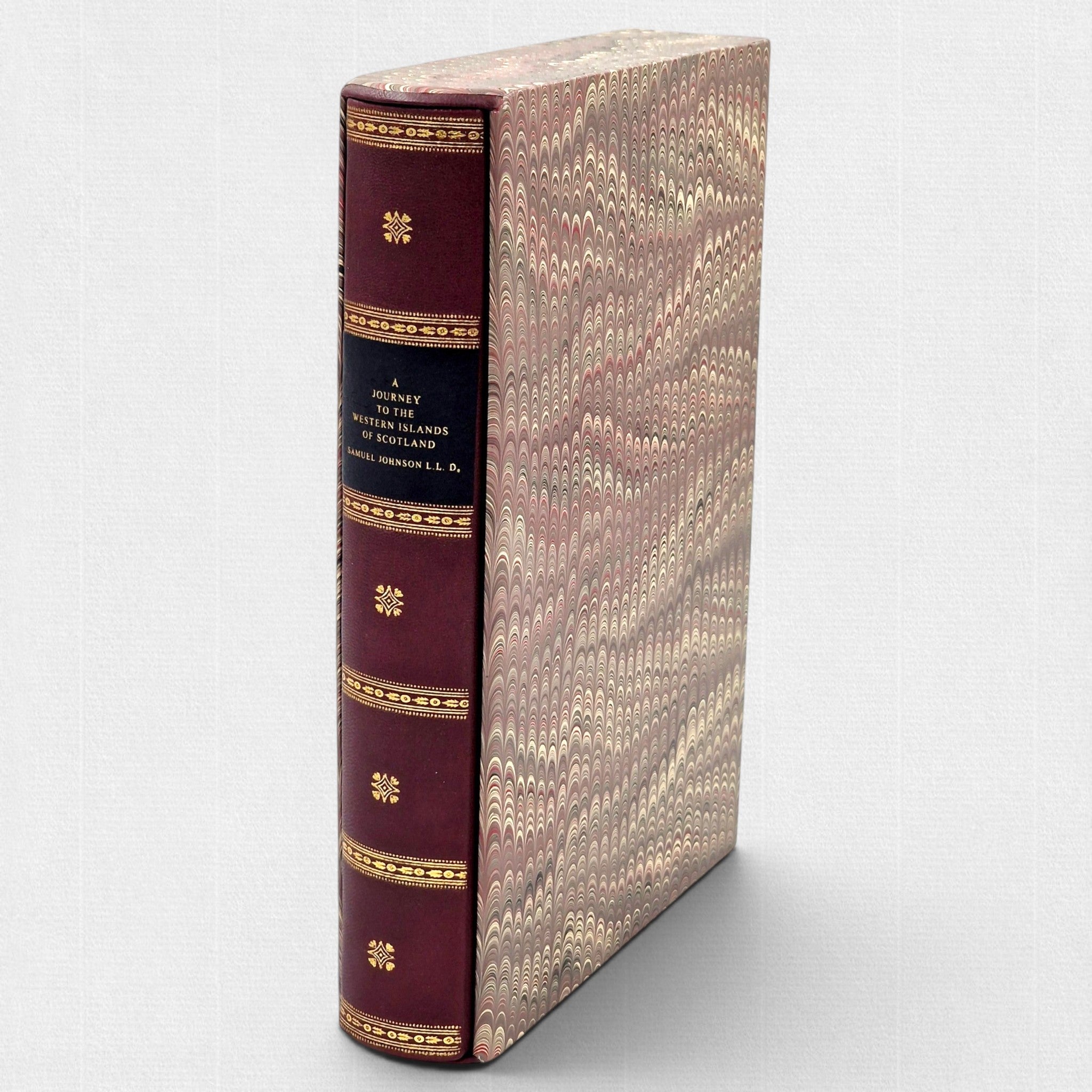 Collector’s edition of Samuel Johnson’s A Journey to the Western Islands of Scotland, published by Woodbank Press, featuring a hand-bound leather binding, gilt spine decoration, marbled slipcase, and fine press production in a limited edition of 25 copies.
