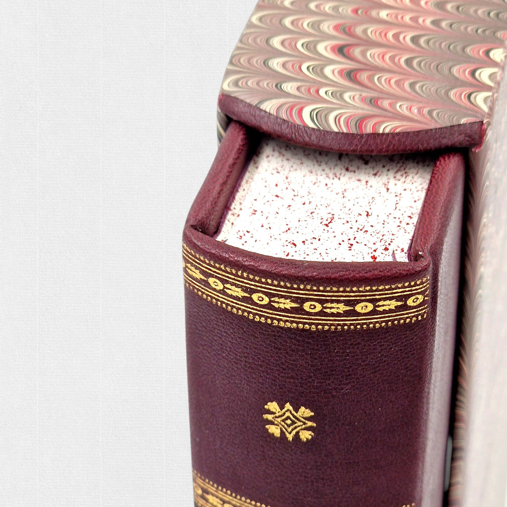 Close-up of the gilt-tooled leather spine and marbled slipcase of Samuel Johnson's A Journey to the Western Islands of Scotland, a limited fine press edition published by Woodbank Press.