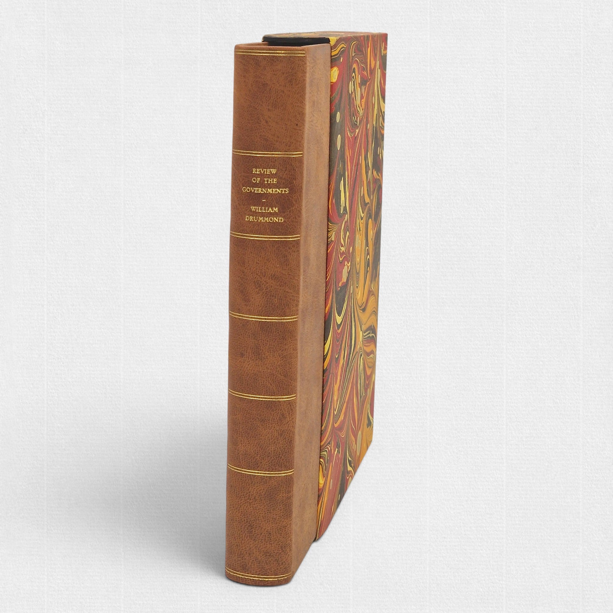 Spine view of A Review of the Governments of Sparta and Athens by Sir William Drummond, limited fine press edition by Woodbank Press, hand-bound in full leather with gilt-lettered spine and marbled slipcase.
